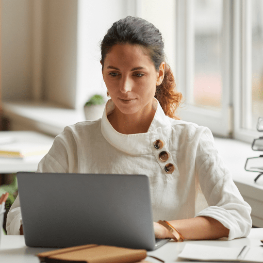 Woman sitting at a desk on a laptop