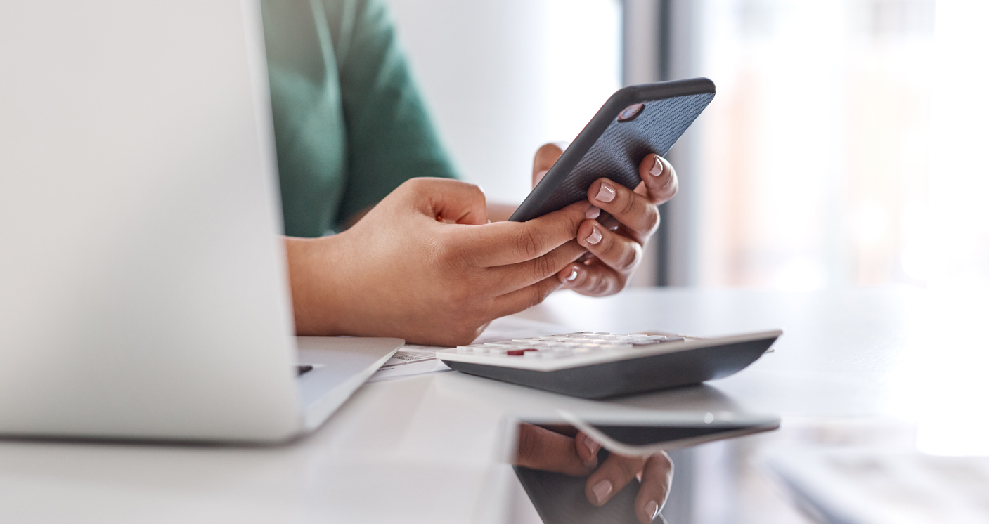 Finance pro looking at his devices while working