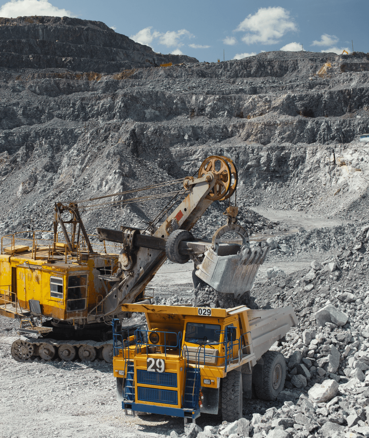 Heavy machinery moving rocks in a quarry.