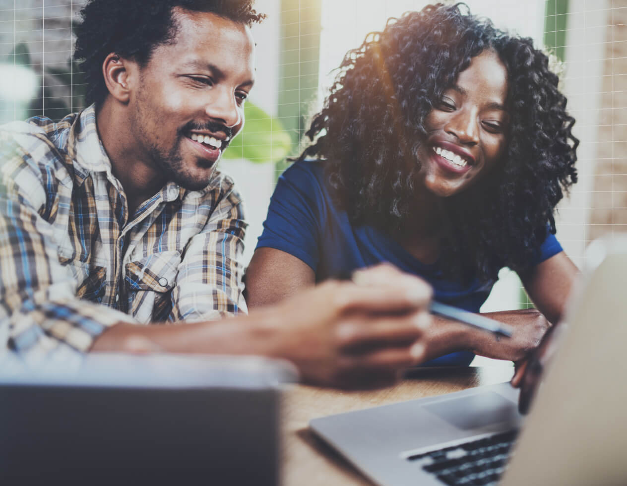 African American couple working together on a laptop computer.