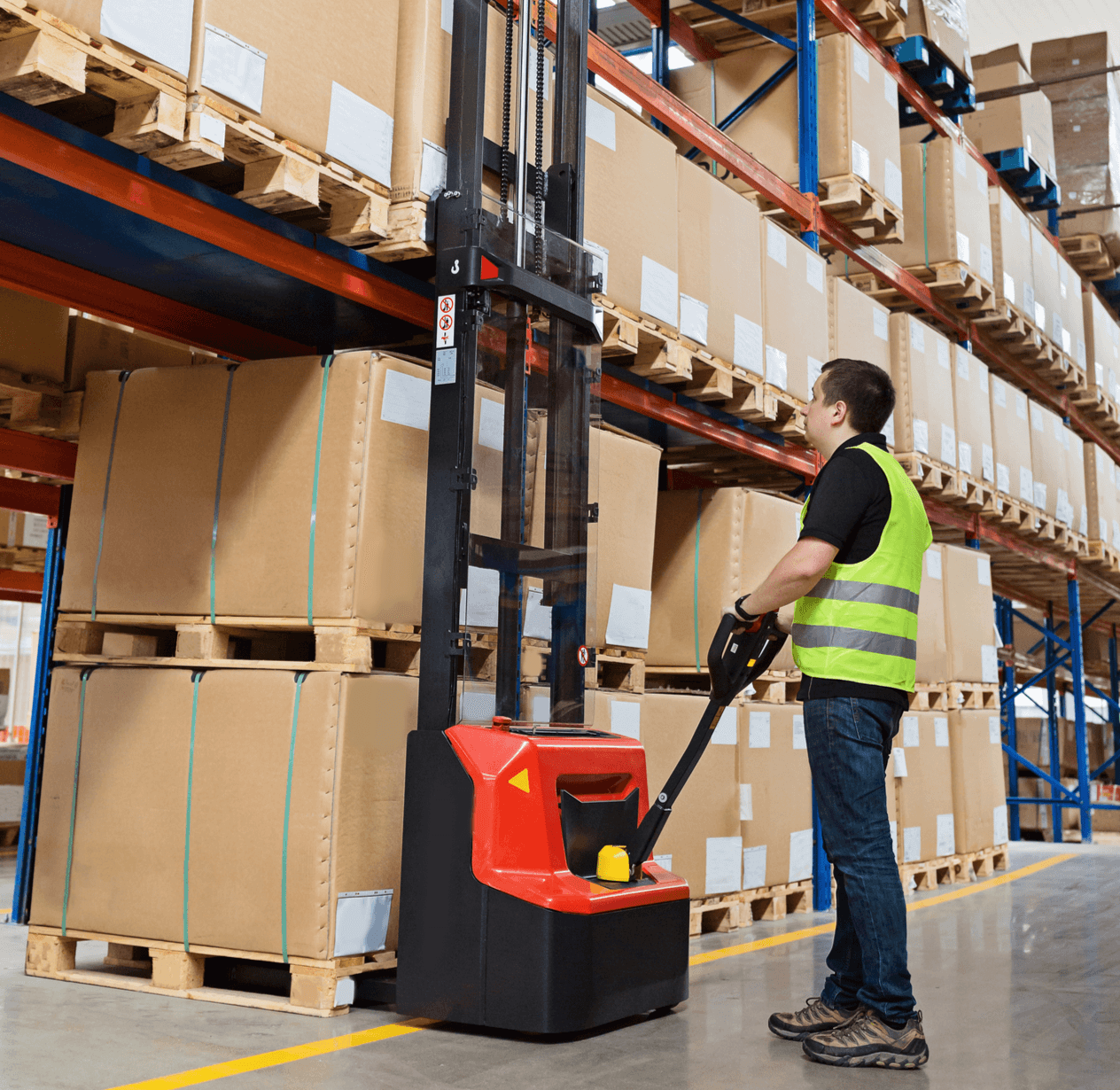 Man using forklift in a warehouse.
