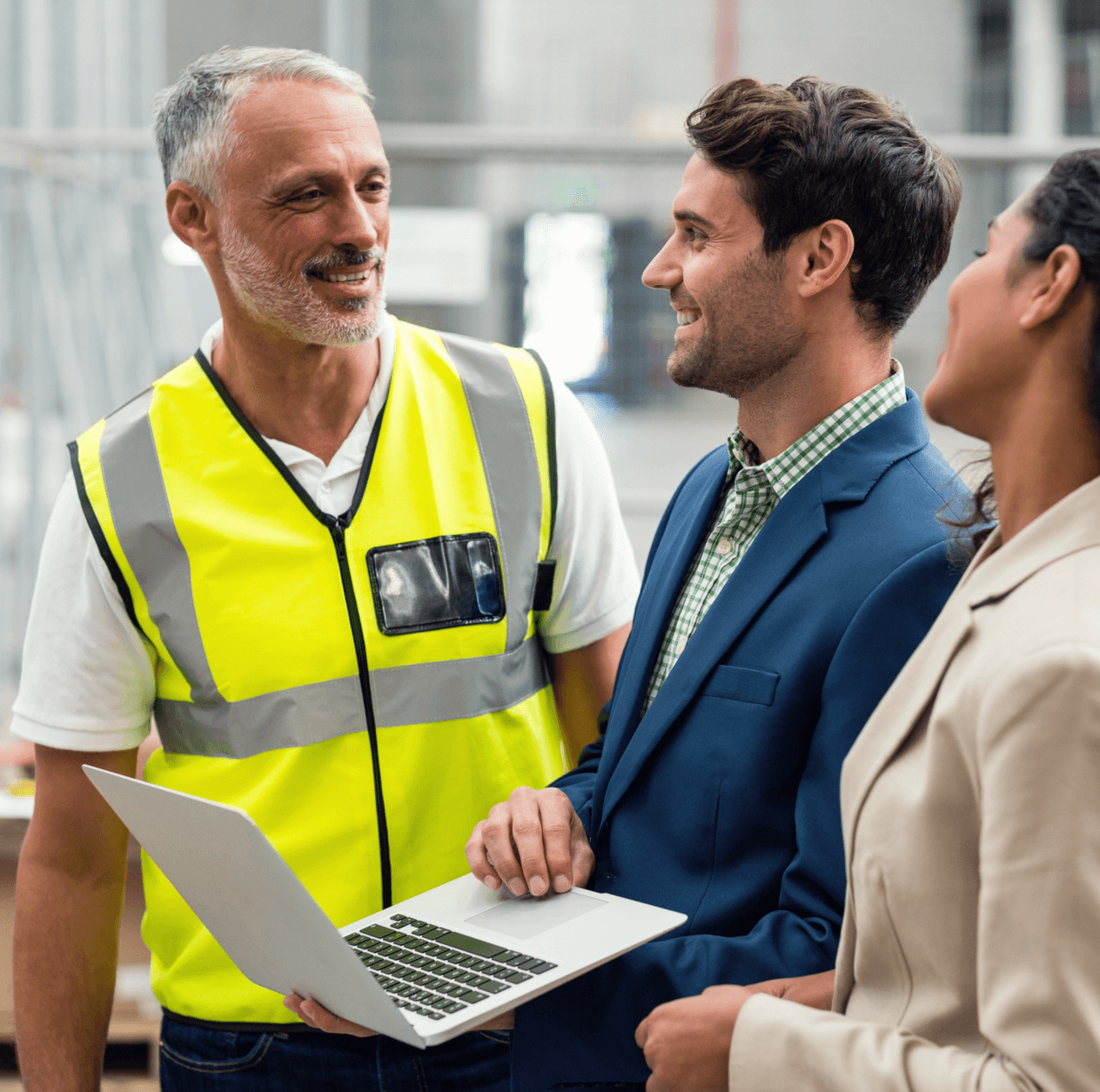 Warehouse workers and managers having a friendly discussion.