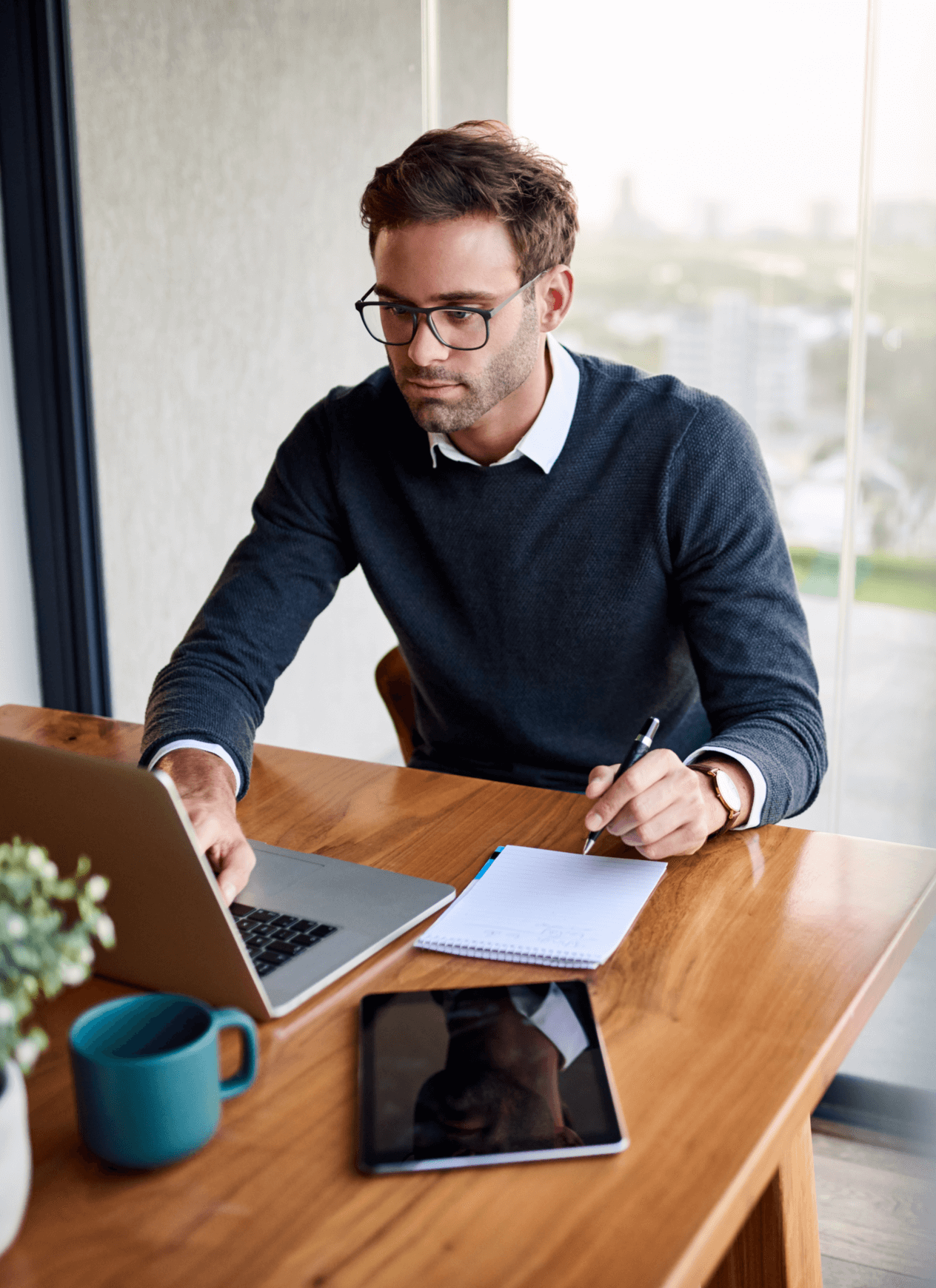 Man working on a laptop at a desk.