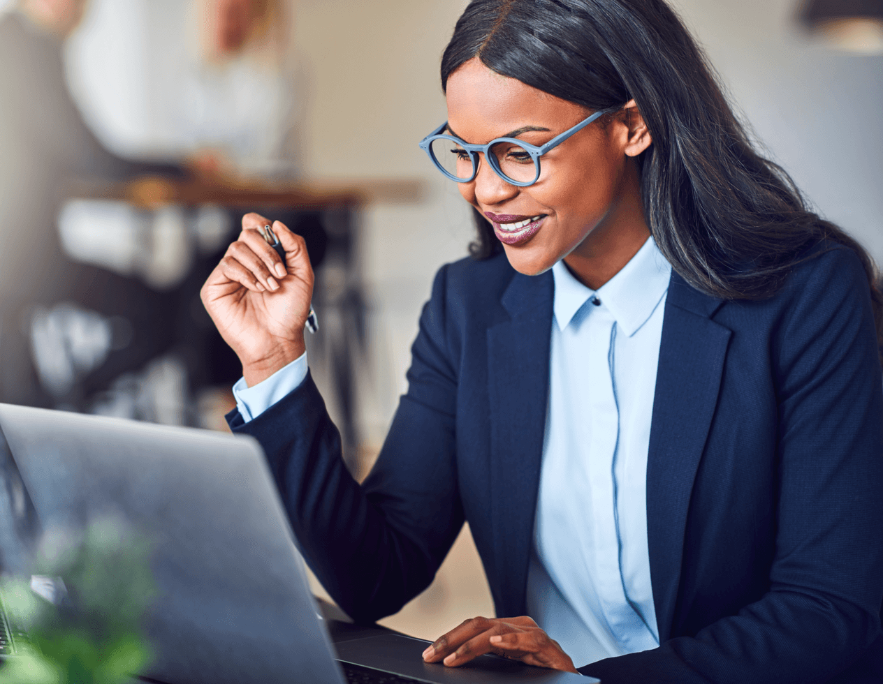 Smiling African American woman working at a laptop computer