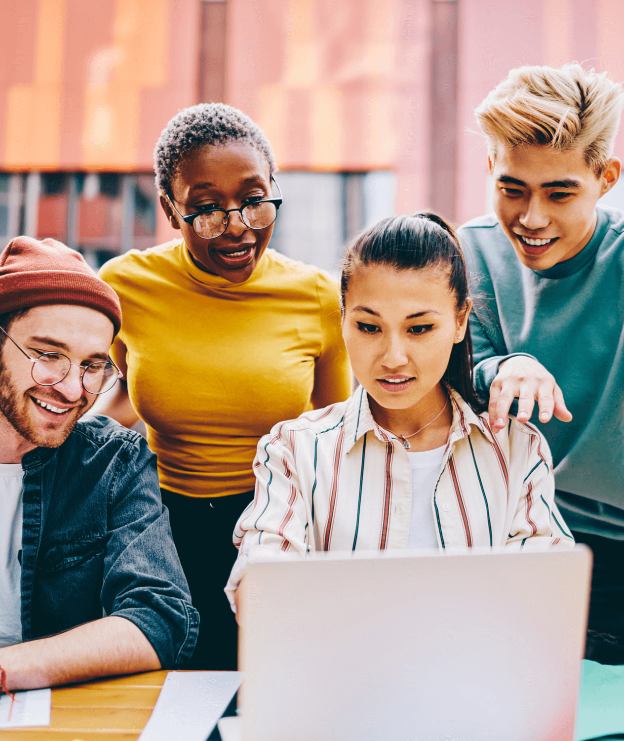 Multicultural group of students dressed in casual wear watching online webinar on modern laptop computer using wireless internet connection outdoors.