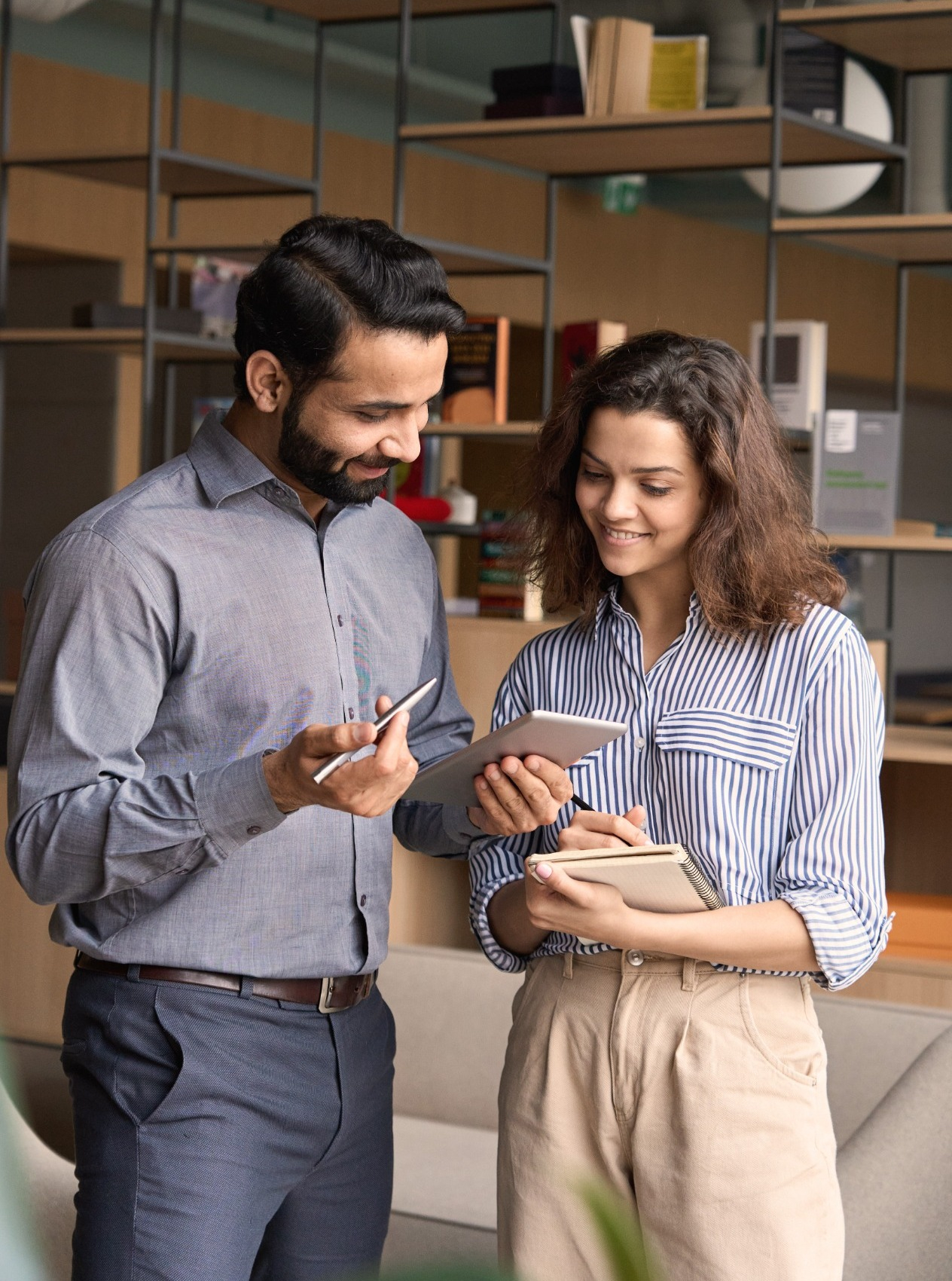 Two people looking at a notepad