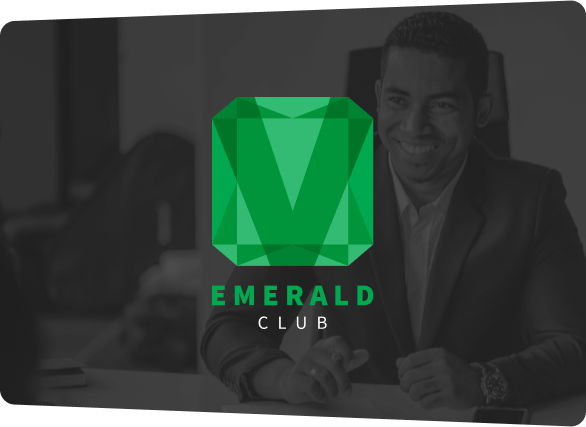 Emerald Club logo (green square-shaped gem with V inside) over background of man in suit smiling. 
