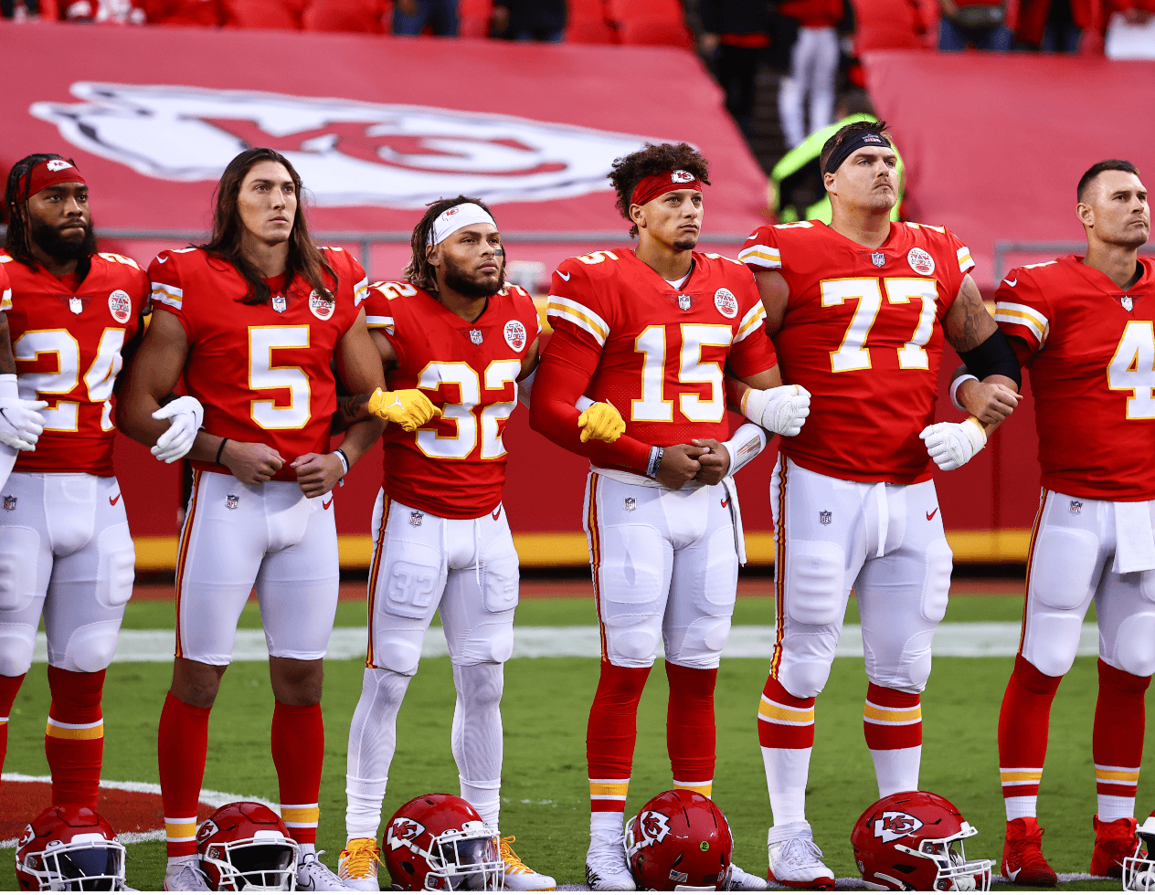 Kansas City Chiefs players stand arm-in-arm during a social justice demonstration ahead of their NFL football game against the Houston Texans on Sept. 10, 2020. Players pictured are Chad Henne, Andrew Wylie, Patrick Mahomes, Tyrann Mathieu, Tommy Townsend and former safety Tedric Thompson.