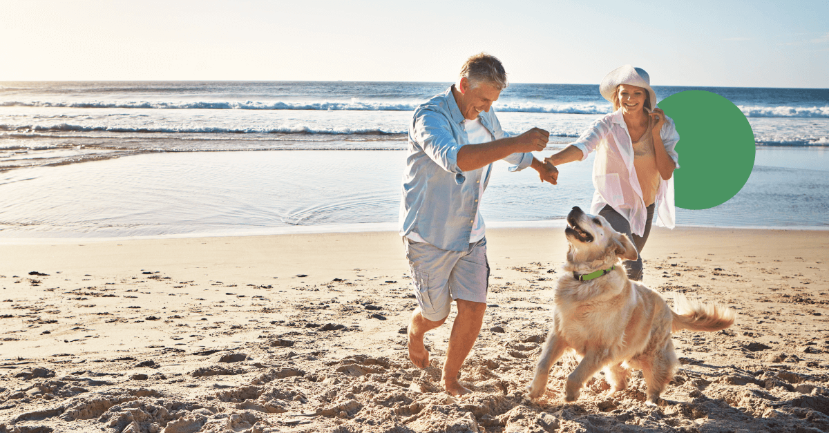 A couple and and their dog on a beach