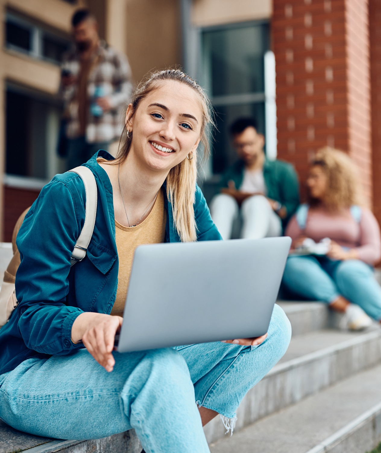 University student holding laptop