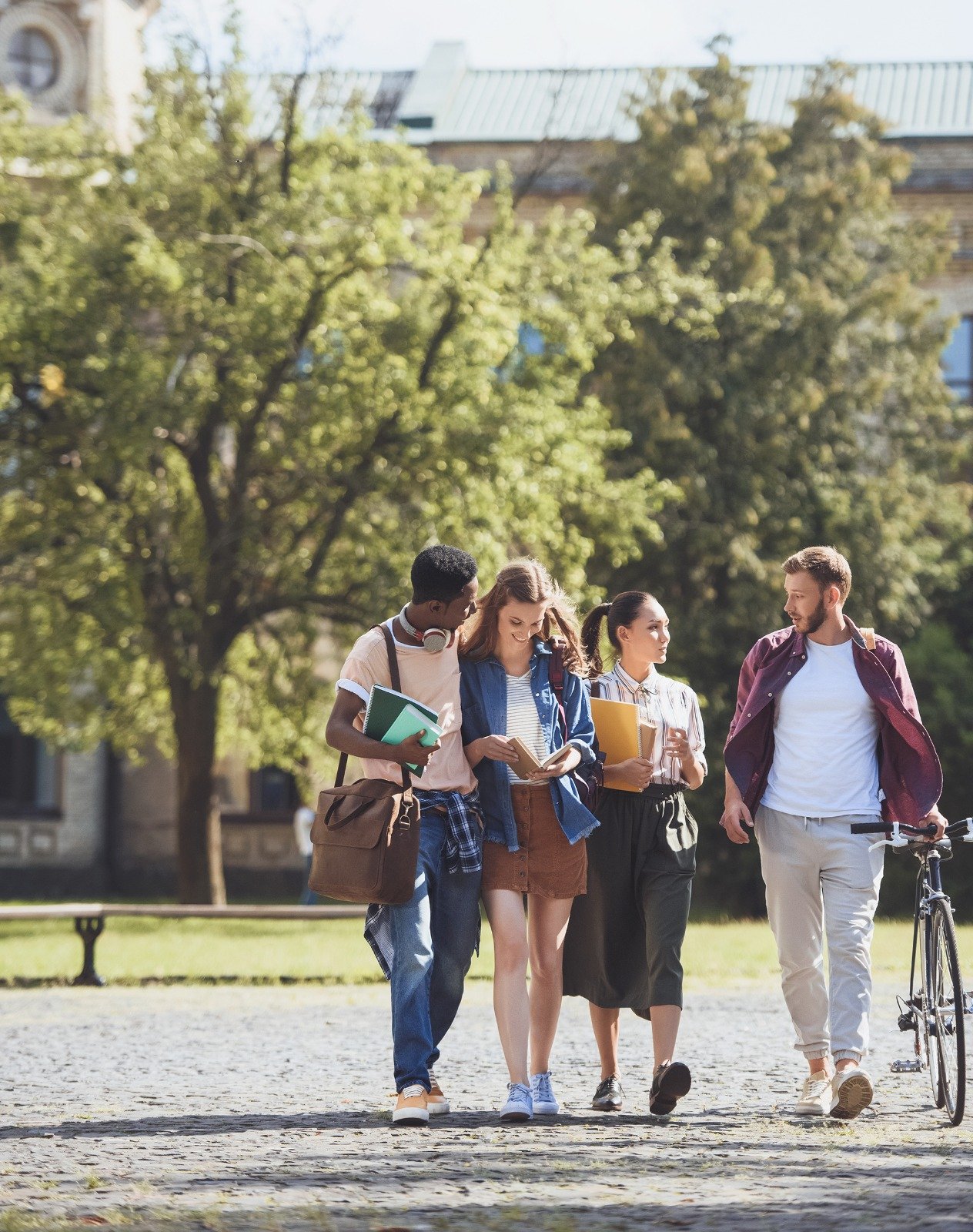 Four university students walking together