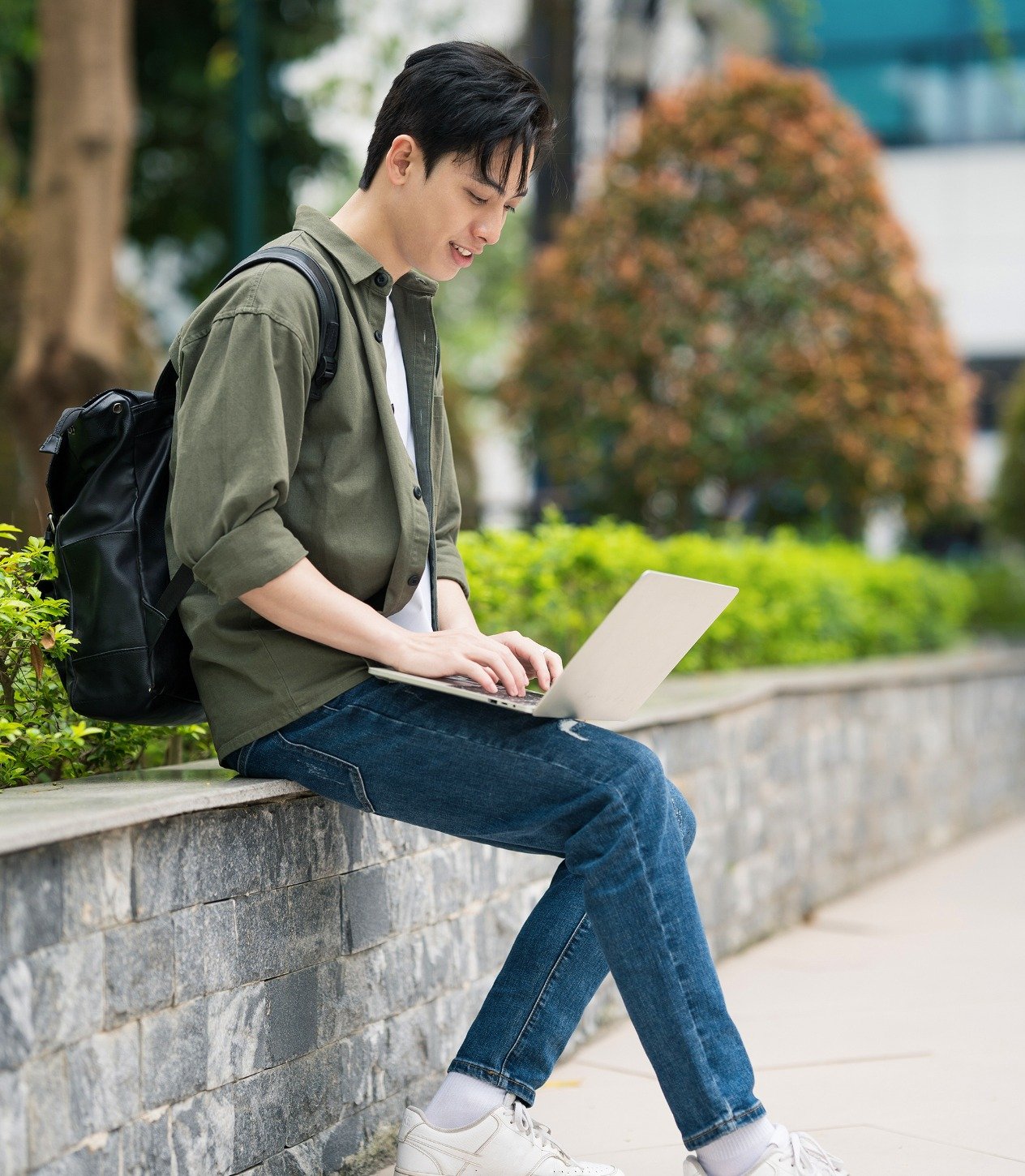 University student holding laptop