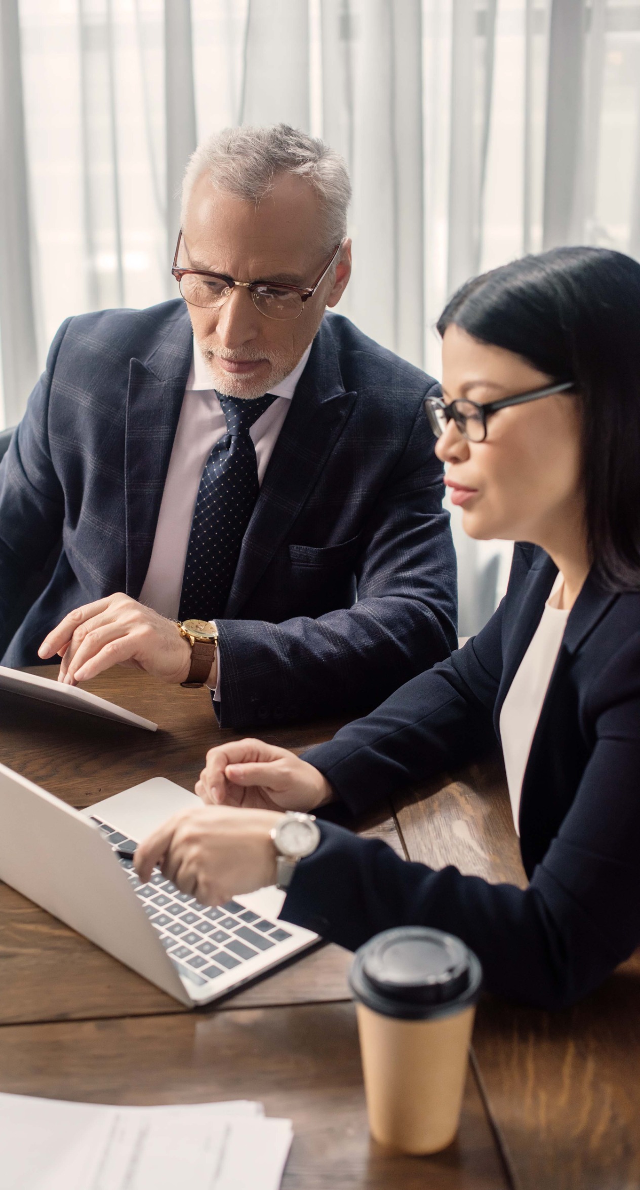 Two people looking at a laptop