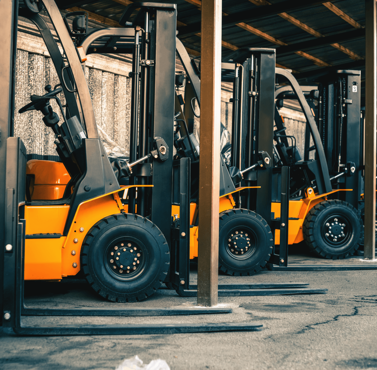 A fleet of yellow forklifts.