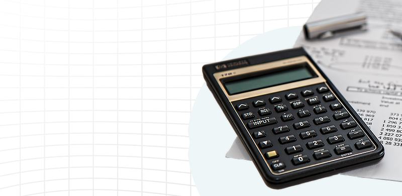 Calculator and sheet of paper over a grid background 