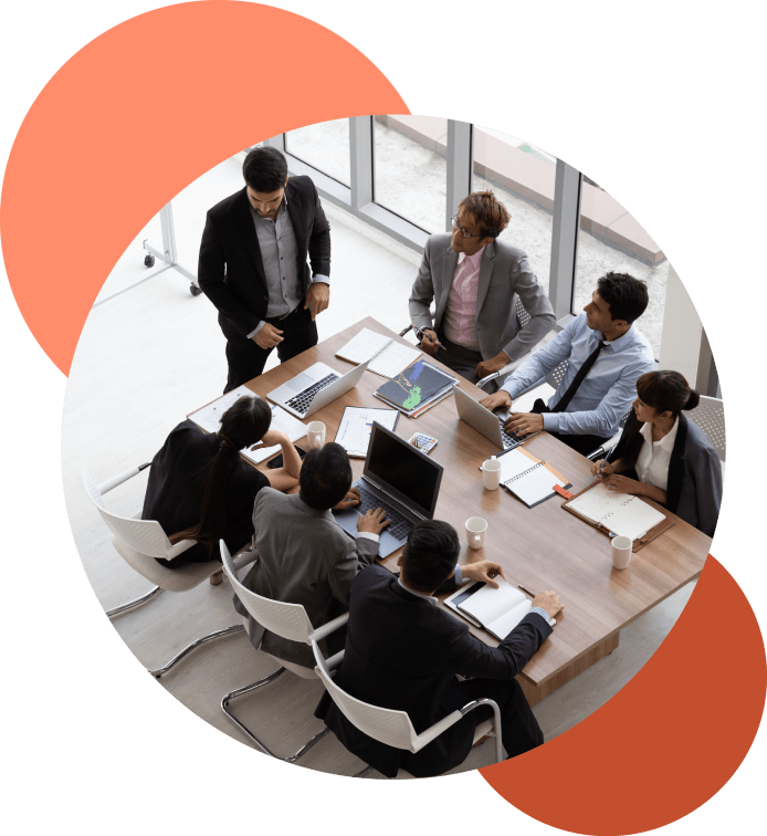 A birds eye view of people collaborating around a desk in an office