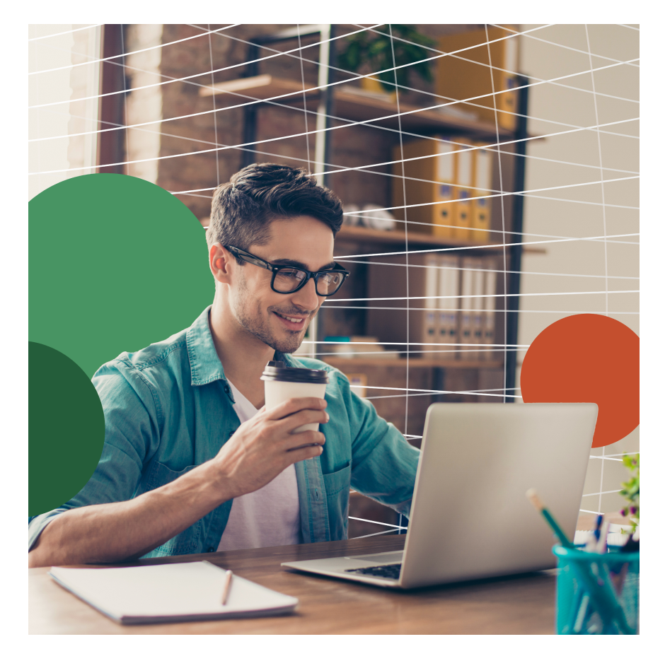 Man holding coffee cup, looking at laptop.