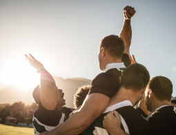 Image of men celebrating on a soccer field